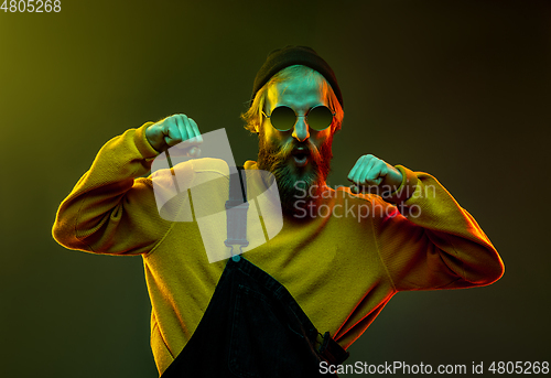 Image of Caucasian man\'s portrait isolated on gradient studio background in neon light