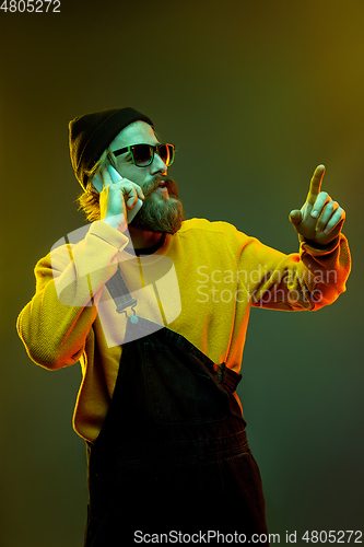 Image of Caucasian man\'s portrait isolated on gradient studio background in neon light
