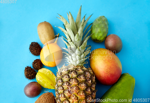 Image of many different exotic fruits on blue background