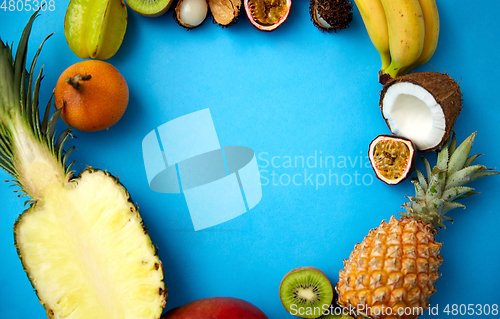 Image of different exotic fruits on blue background