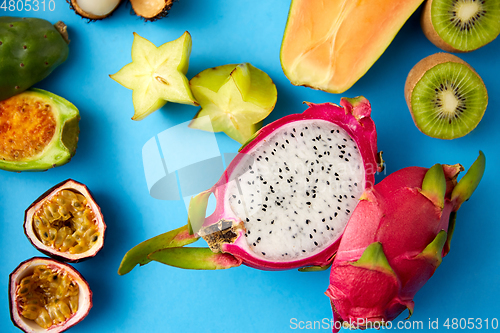 Image of different exotic fruits on blue background