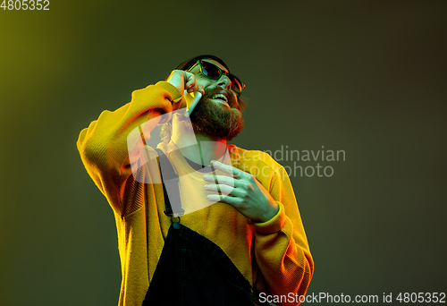 Image of Caucasian man\'s portrait isolated on gradient studio background in neon light