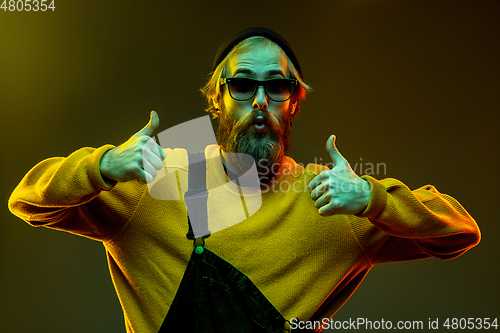 Image of Caucasian man\'s portrait isolated on gradient studio background in neon light