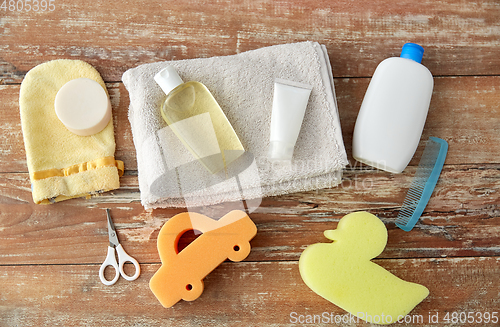 Image of baby accessories for bathing on wooden table