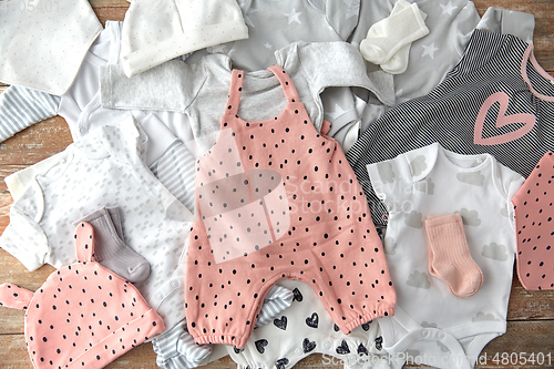 Image of baby clothes set on wooden table