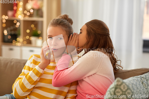 Image of teenage girls gossiping at home