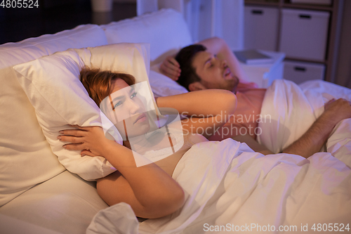 Image of woman suffering from insomnia or snoring man