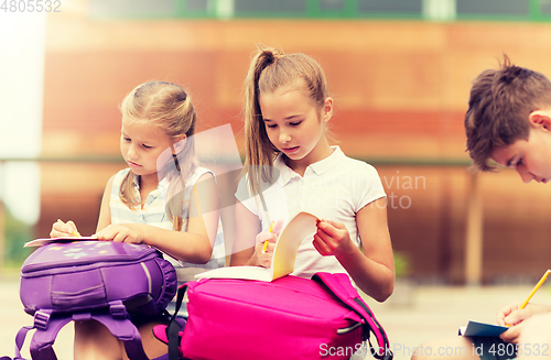 Image of group of happy elementary school students outdoors