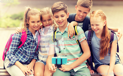 Image of happy elementary school students taking selfie