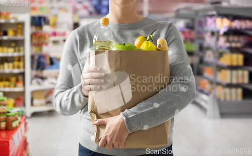 Image of close up of woman with paper bag full of food