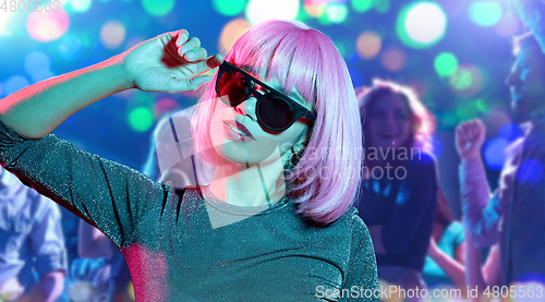 Image of woman in pink wig and sunglasses at nightclub