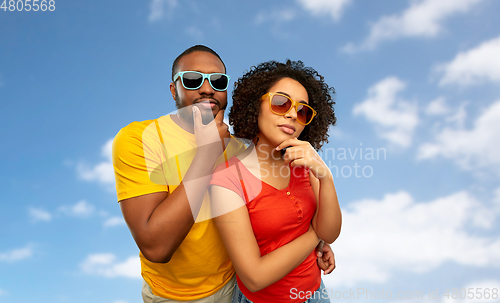 Image of african couple in sunglasses thinking