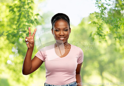 Image of happy african american woman showing peace