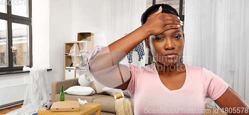 Image of stressed african american woman over dirty room