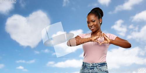 Image of african american woman making hand heart gesture