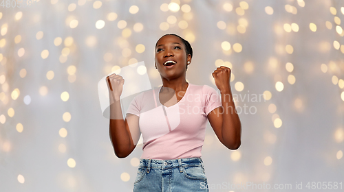 Image of happy african american woman celebrating success