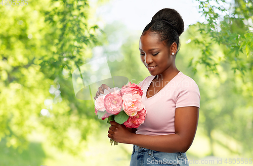 Image of happy african american woman with bunch of flowers