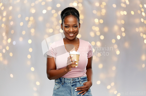 Image of happy african american woman drinking coffee