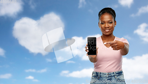 Image of happy african american woman using smartphone