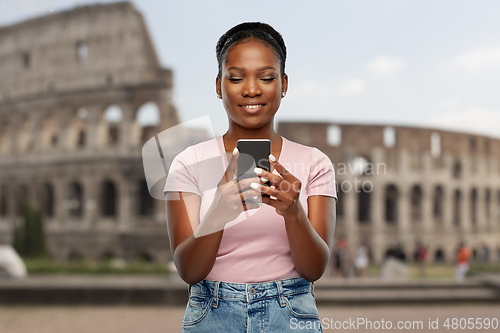 Image of african american woman with smartphone at coliseum
