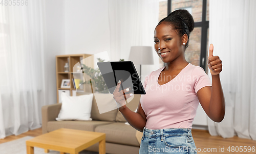 Image of african american woman showing thumbs up at home