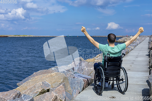 Image of Disabled man in a wheelchair at the sea