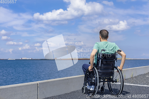 Image of Disabled man in a wheelchair at the sea