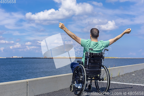 Image of Disabled man in a wheelchair at the sea