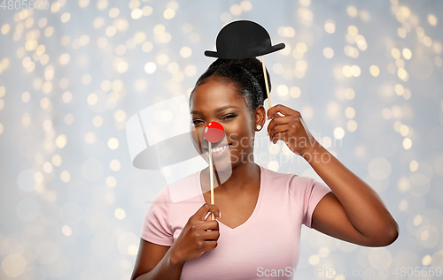 Image of happy african american woman with red clown nose