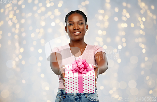 Image of happy african american woman with birthday present