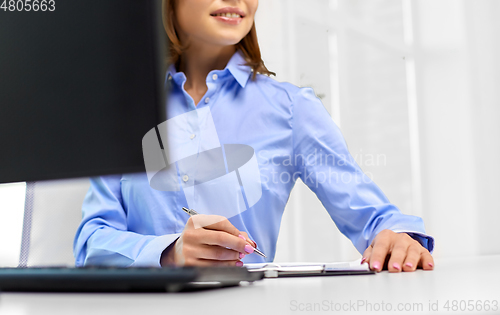 Image of businesswoman with papers working at office