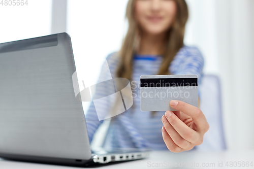 Image of teenage girl with laptop and credit card at home