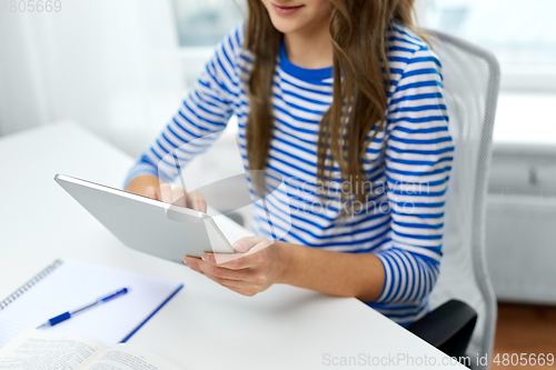 Image of student girl using tablet pc computer at home