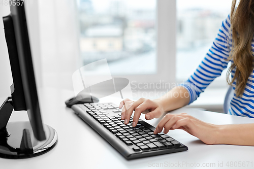 Image of close up of teenage girl with computer at home