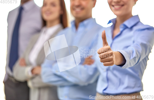 Image of close up of happy businesswoman showing thumbs up