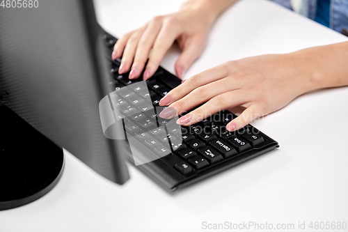 Image of female hands typing on computer keyboard