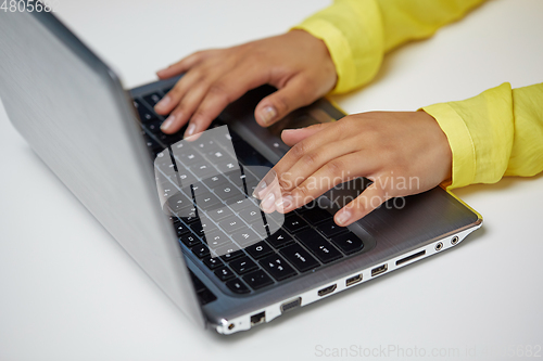 Image of african american student girl typing on laptop