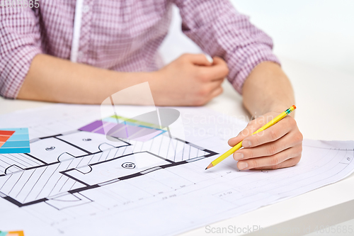 Image of architect with blueprint and color palettes