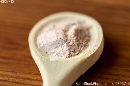 Image of close up of wooden spoon with pink himalayan salt