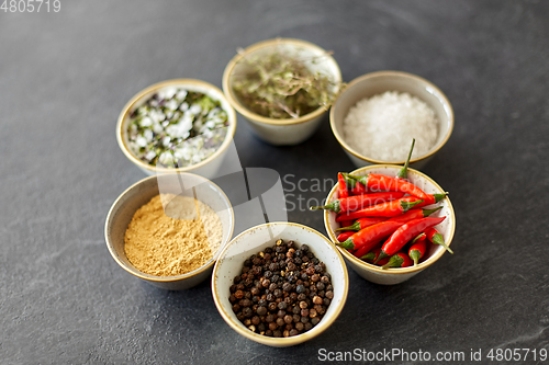 Image of bowls with different spices on slate stone table