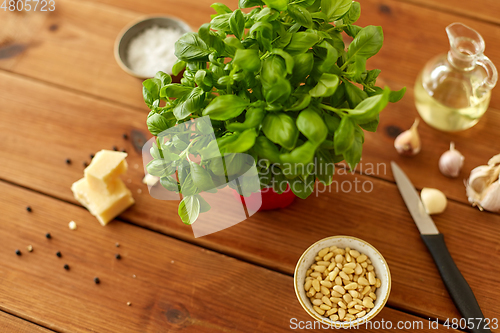 Image of ingredients for basil pesto sauce on wooden table