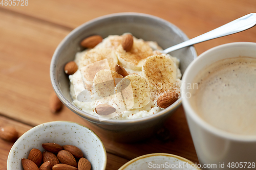 Image of oatmeal with banana and almond on wooden table