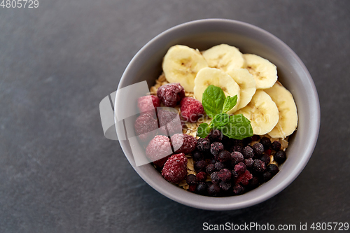 Image of cereal breakfast with berries, banana and mint