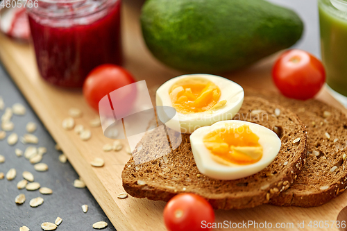 Image of toast bread with eggs, cherry tomatoes and avocado