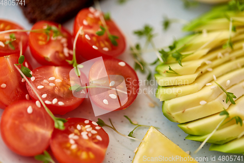 Image of cherry tomatoes and sliced avocado with thyme