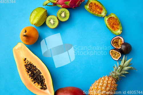 Image of different exotic fruits on blue background