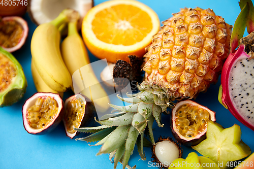 Image of different exotic fruits on blue background