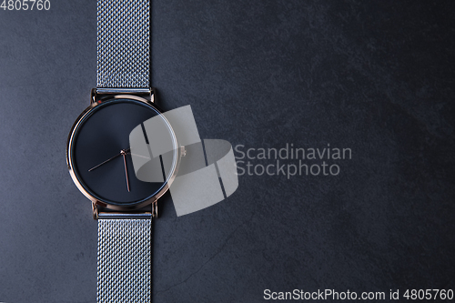 Image of Wrist watch with metal strap for women on gray background