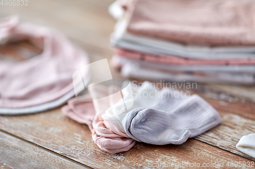 Image of close up of baby clothes on wooden table