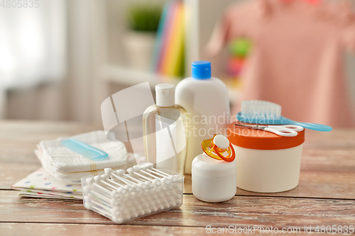 Image of baby accessories for bathing on wooden table